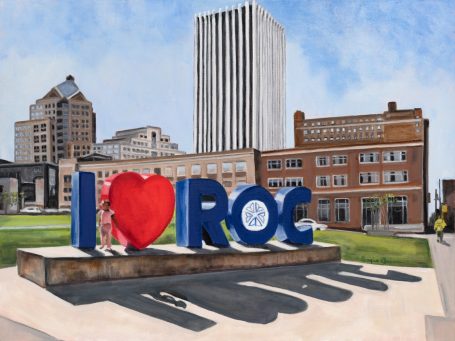 "I ♥ ROC" Colorful "I ♥ ROC" sign in a city park with buildings in the background.