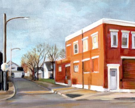 Portland Ave. Sunset Red brick building in a quiet street with bare trees under a cloudy sky.