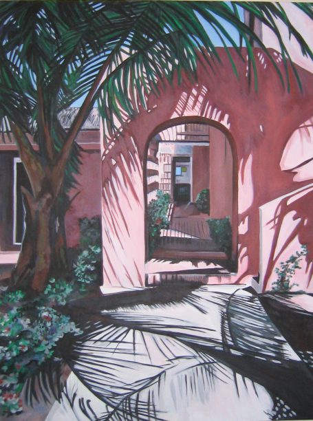 Peace and Plenty Club Pink building archway framed by palm trees and shadowed walkway.